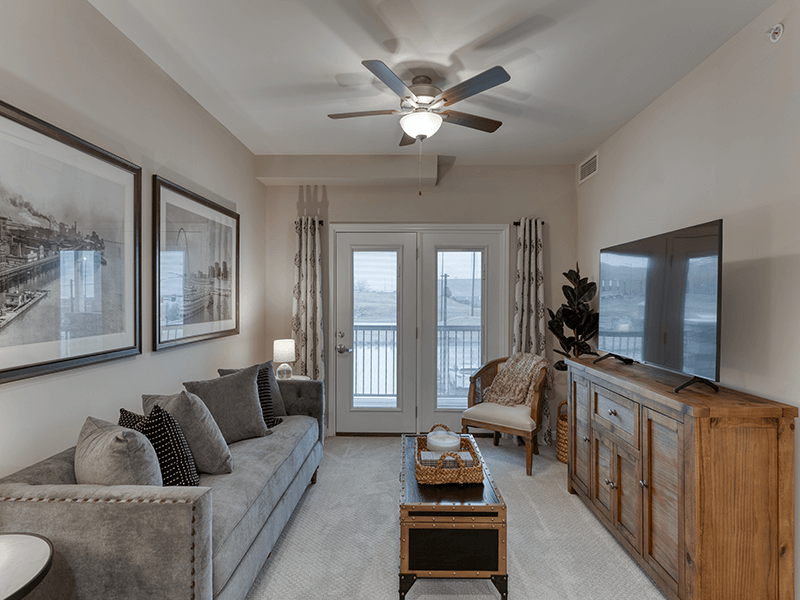 A spacious and bright living room inside a senior apartment at Cedarhurst of Arnold