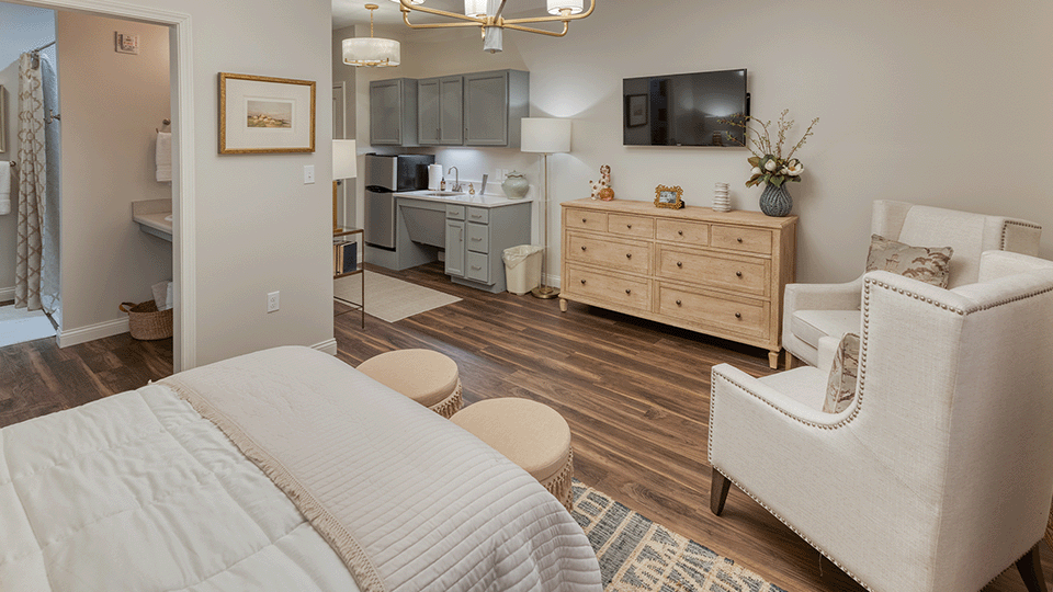 A spacious and bright living room inside a senior apartment at Cedarhurst of Beaumont.