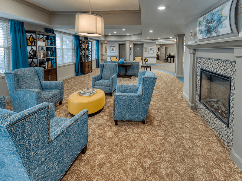Cedarhurst of Beaumont's inviting common area, designed with senior-friendly seating and a warm fireplace for relaxation and warmth.