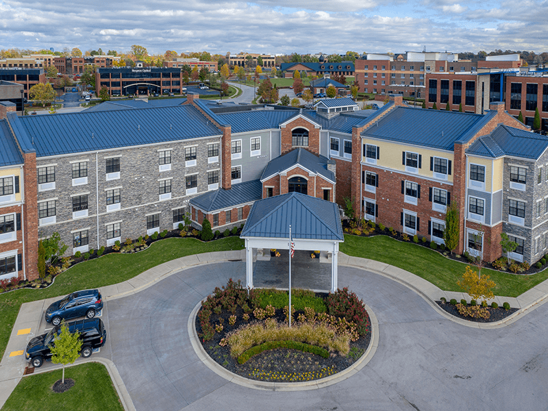 The inviting front exterior of the Cedarhurst of Beaumont senior living community building.