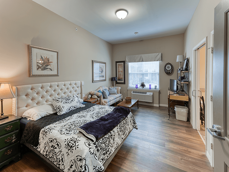 Bedroom space within a senior studio apartment at Cedarhurst of Beaumont, offering a private and cozy retreat.