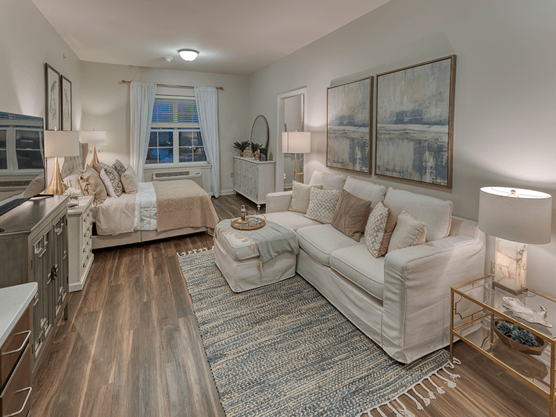 Bedroom space within a senior studio apartment at Cedarhurst of Beaumont, offering a private and cozy retreat.