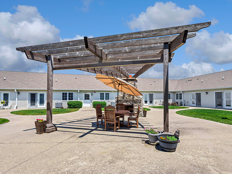 Shaded outdoor area at Cedarhurst of Bethalto, complete with a beautiful pergola for comfort and relaxation