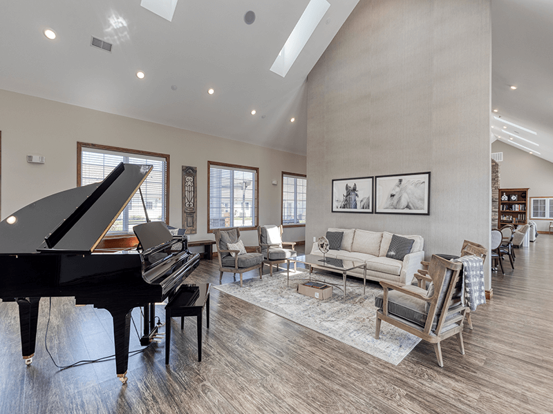 Common area—complete with a piano and ample seating—where residents can enjoy music and relaxation
