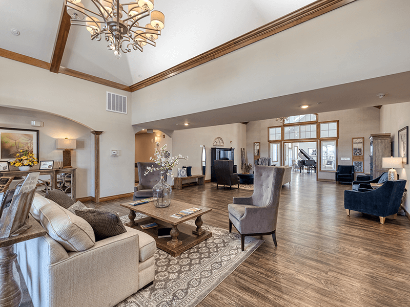 A welcoming common area at Cedarhurst of Bethalto, featuring ample seating and a television, perfect for relaxation or watching programs