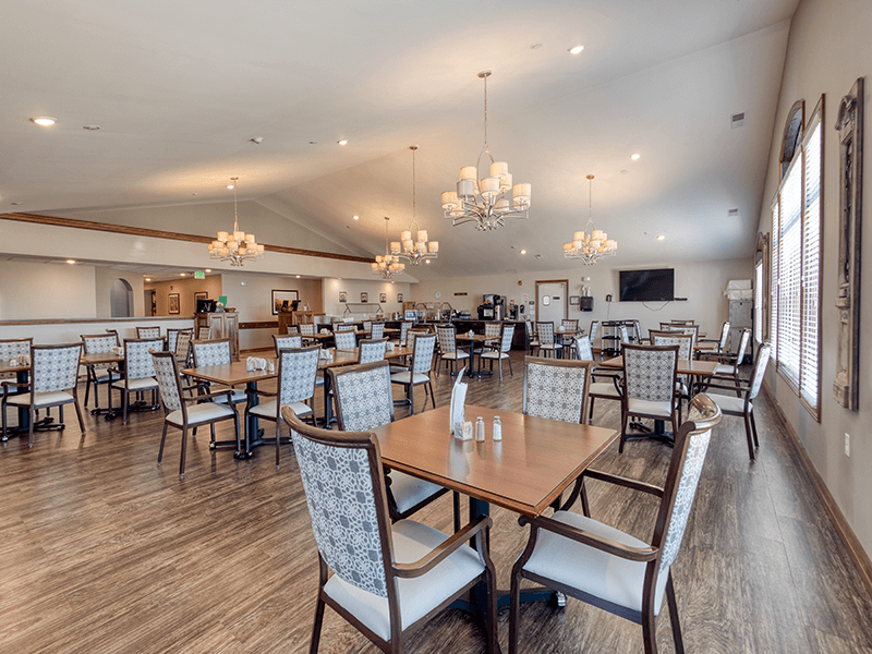 A spacious and bright dining room at Cedarhurst of Bethalto, offering comfortable seating for all-day dining.