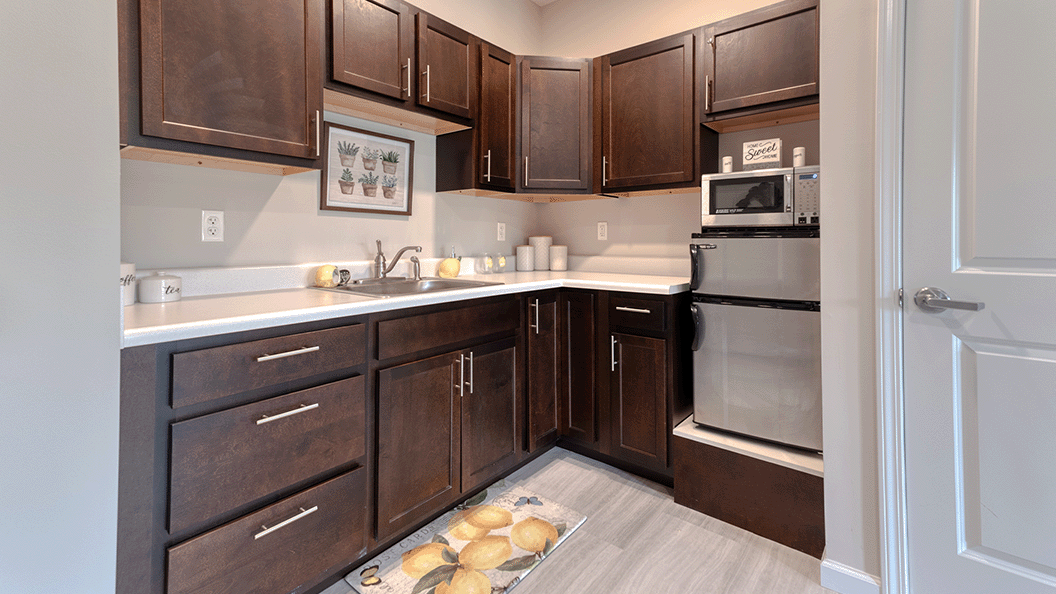 An accessible kitchenette in a senior apartment at Cedarhurst of Blue Springs, designed for ease of use and independence.