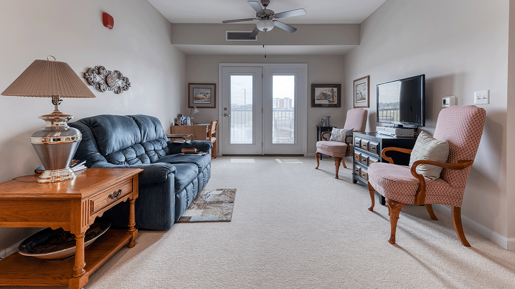 Senior-friendly apartment living room at Cedarhurst of Blue Springs, offering comfortable and accessible design for residents