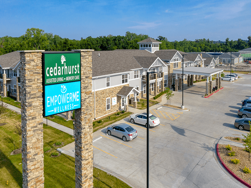 The accessible front entrance of Cedarhurst of Blue Springs, with convenient parking and a senior-friendly design.