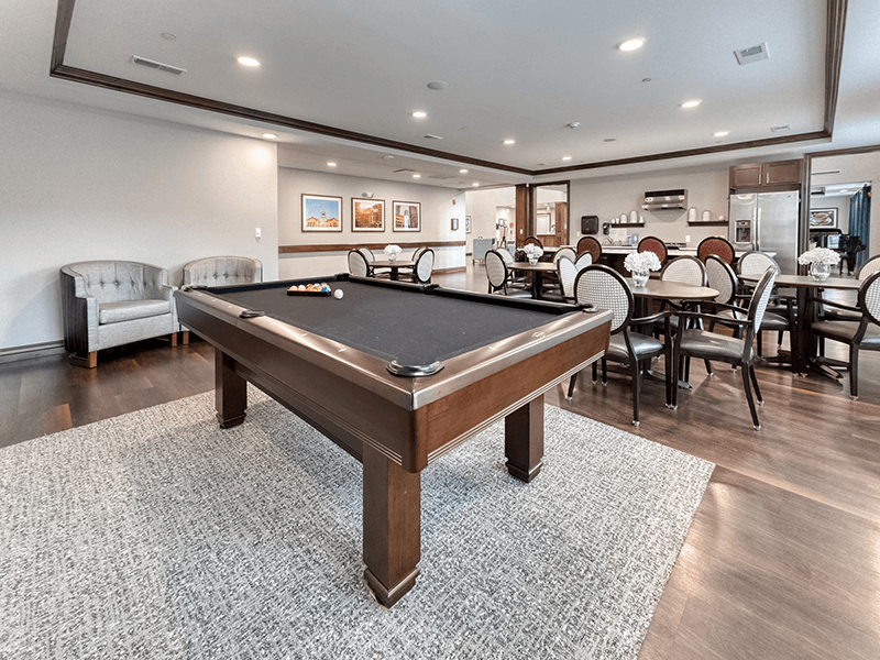 Well-equipped game room at Cedarhurst of Blue Springs, where residents can enjoy a friendly game of pool