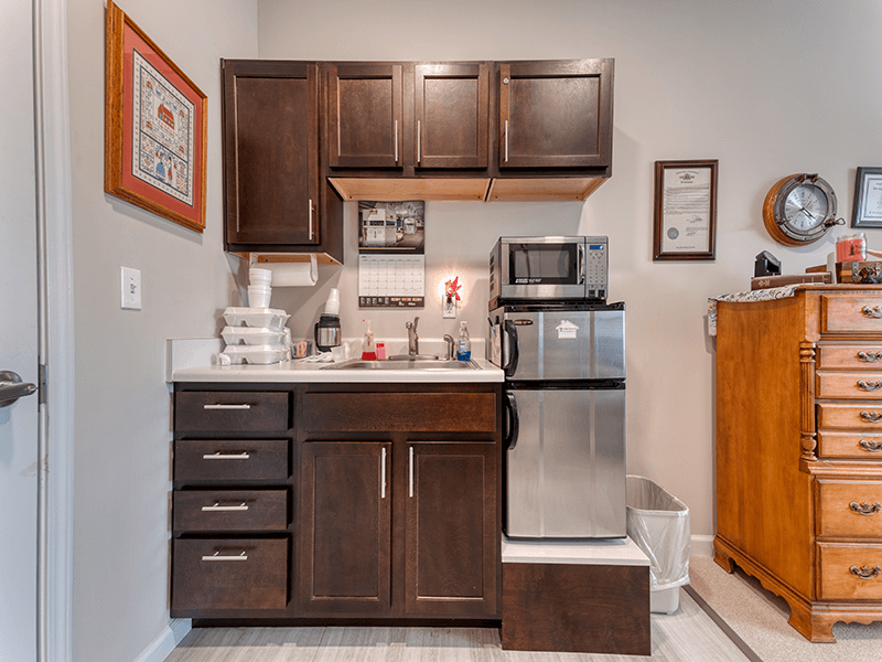 A thoughtfully designed, accessible kitchenette in a senior apartment at Cedarhurst of Blue Springs