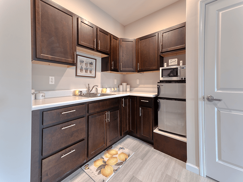 An accessible kitchenette in a senior apartment at Cedarhurst of Blue Springs, designed for ease of use and independence.