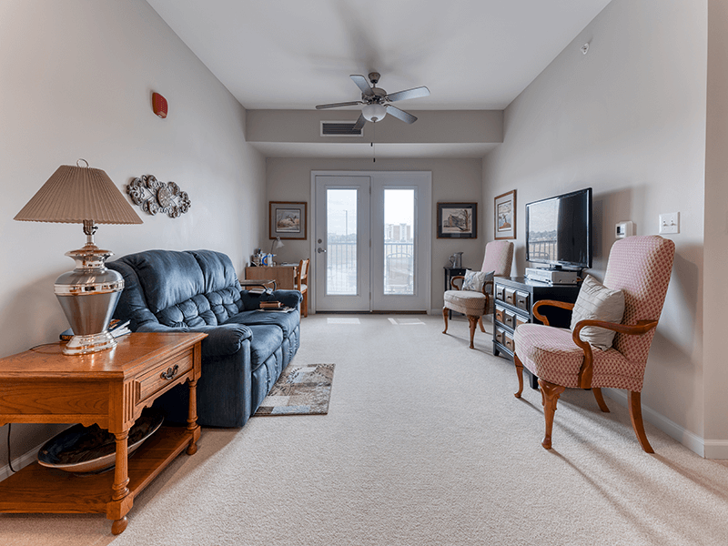 Senior-friendly apartment living room at Cedarhurst of Blue Springs, offering comfortable and accessible design for residents.