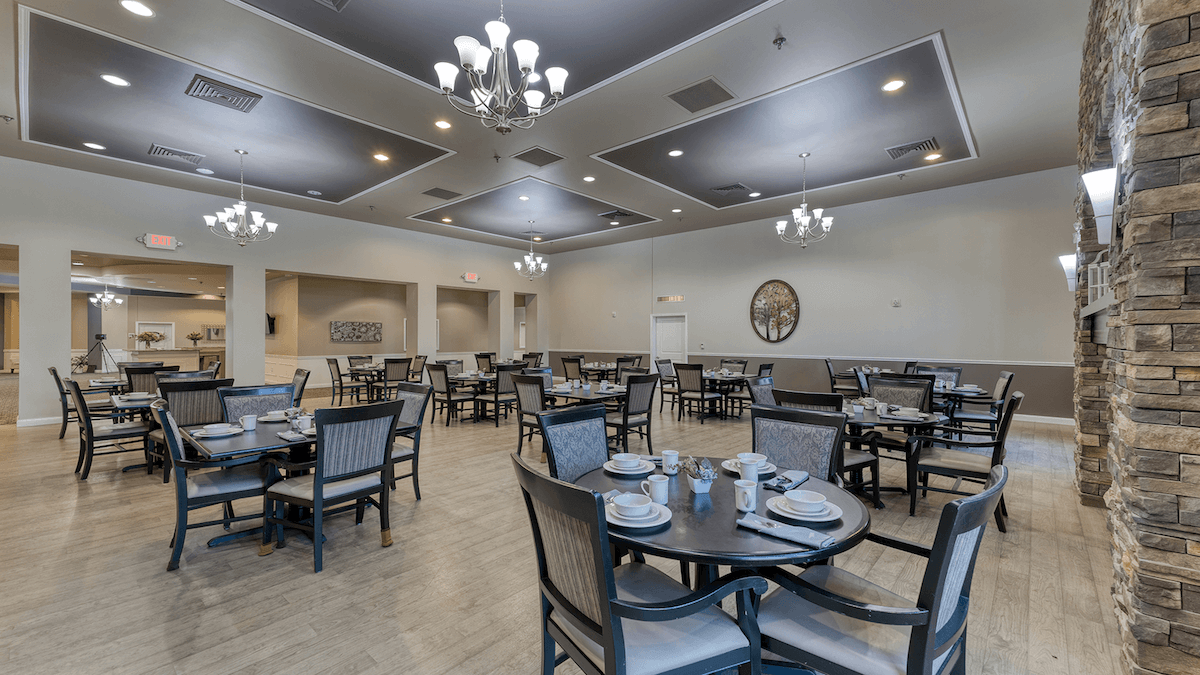 A spacious and bright dining room at Cedarhurst of Breese, offering comfortable seating for meals