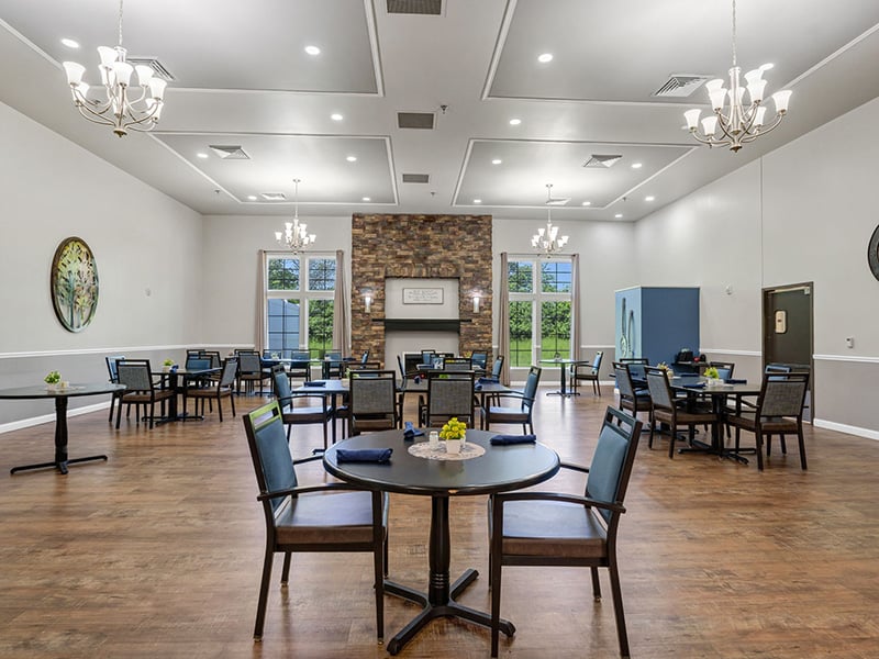 A spacious and bright dining room at Cedarhurst of Breese, offering comfortable seating for meals