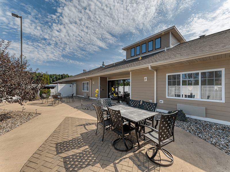 Cedarhurst of Breese's serene outdoor patio, offering ample seating arrangements for residents to enjoy the fresh air.