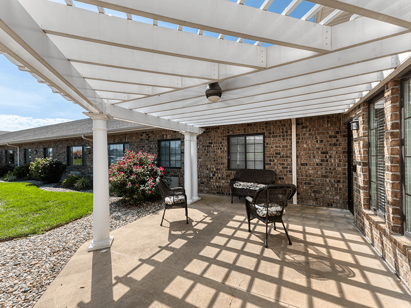 Shaded outdoor area at Cedarhurst of Breese, complete with a beautiful pergola for comfort and relaxation