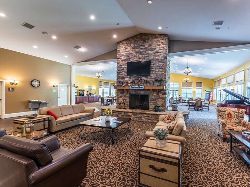 Common area at Cedarhurst of Canton, complete with plush seating and a welcoming fireplace