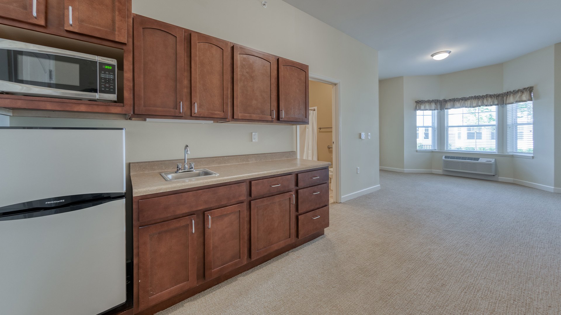 Senior-friendly apartment living room at Cedarhurst of Des Peres, offering comfortable and accessible design for residents