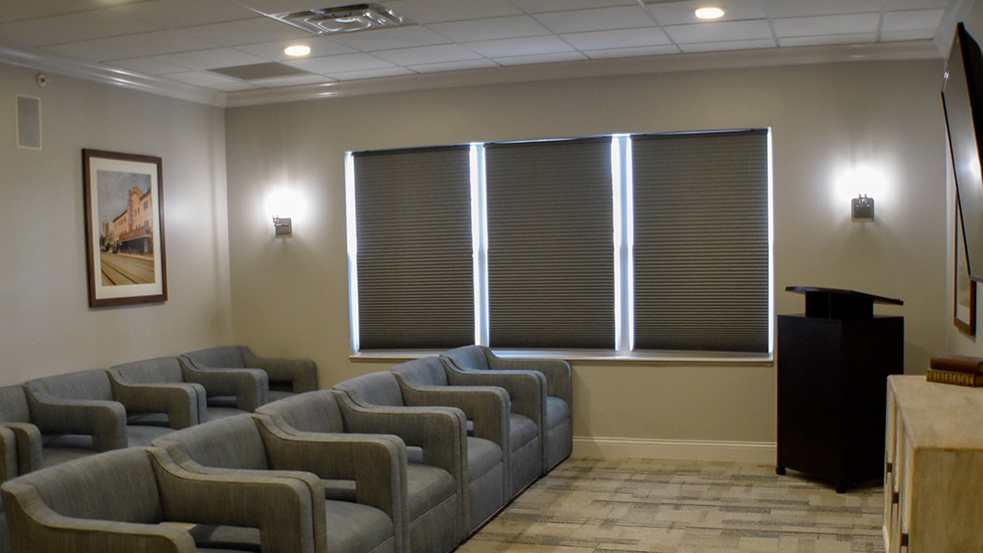 A comfortable and accessible movie theater at Cedarhurst of  Des Peres, featuring a large screen and plush seating for residents' enjoyment