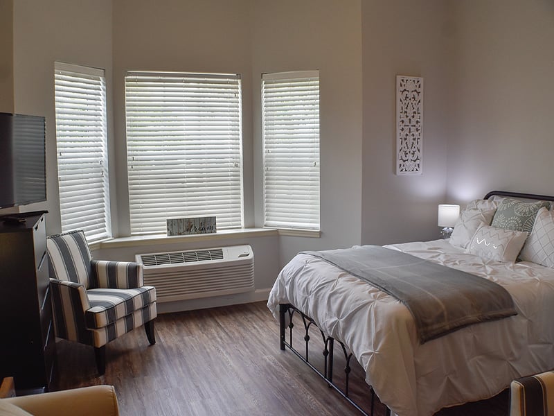 Bedroom of a senior apartment at Cedarhurst of Des Peres, designed for resident comfort and personalization