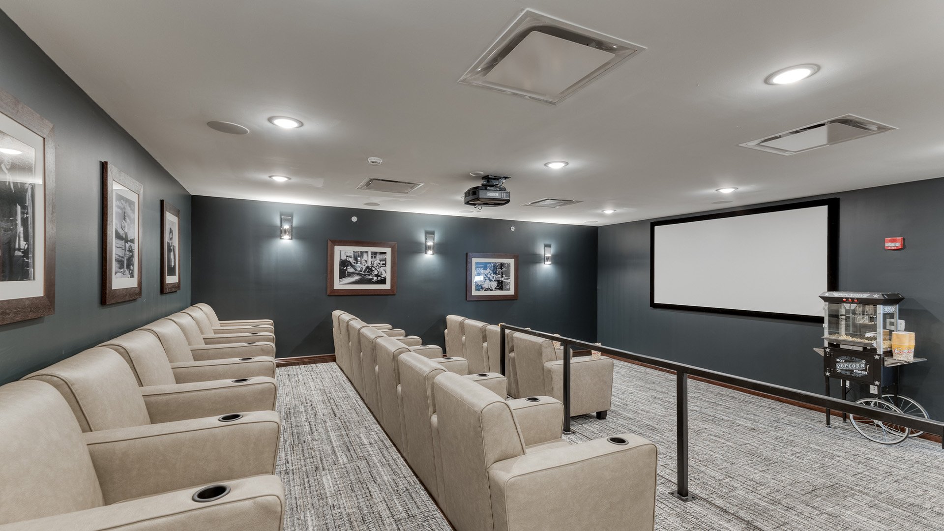 A comfortable and accessible movie theater at Cedarhurst of  Dyer, featuring a large screen and plush seating for residents' enjoyment