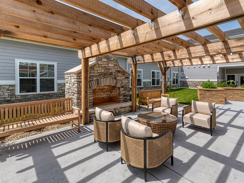 Residents at Cedarhurst of Dyer can enjoy this versatile outdoor patio, which features conversational seating and a warm fireplace