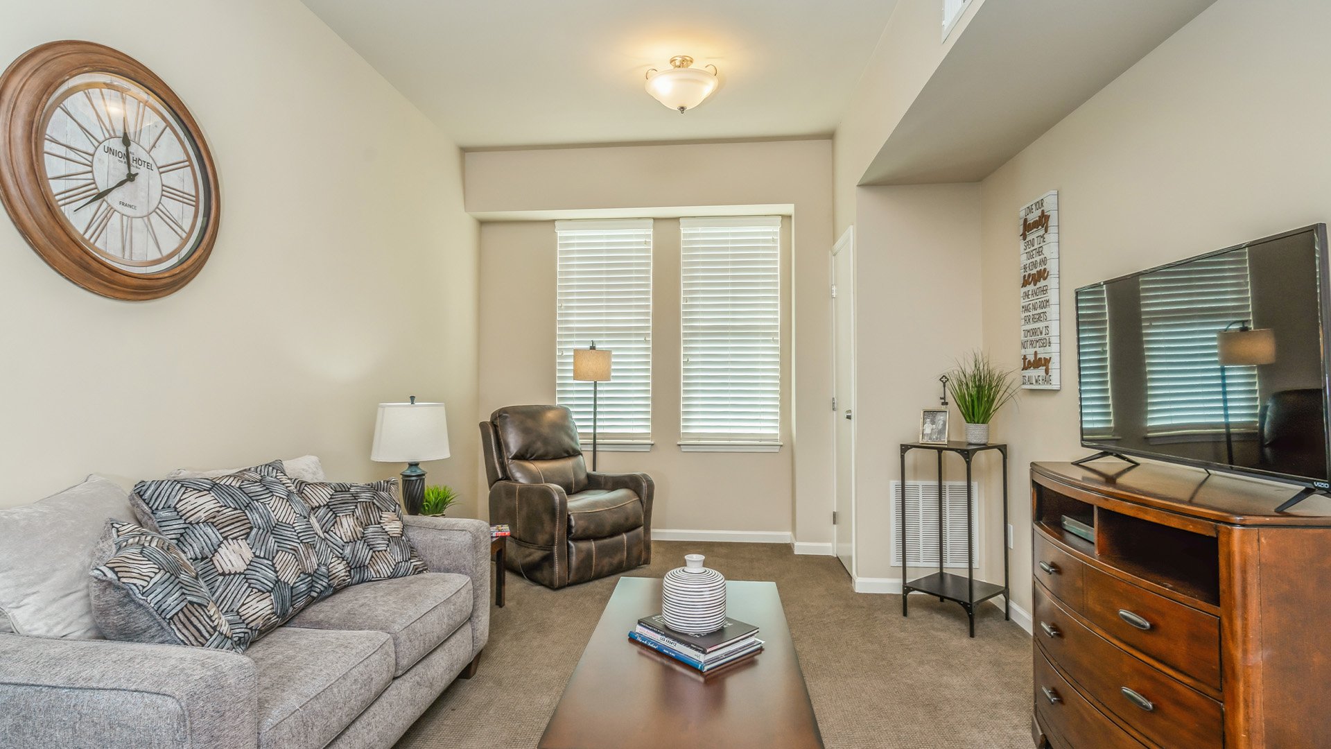 Senior-friendly apartment living room at Cedarhurst of East Louisville, offering comfortable and accessible design for residents