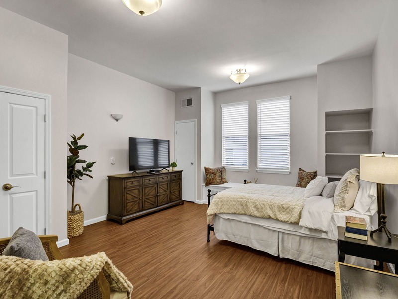 Bright, spacious memory care bedroom with large windows at Cedarhurst of East Louisville