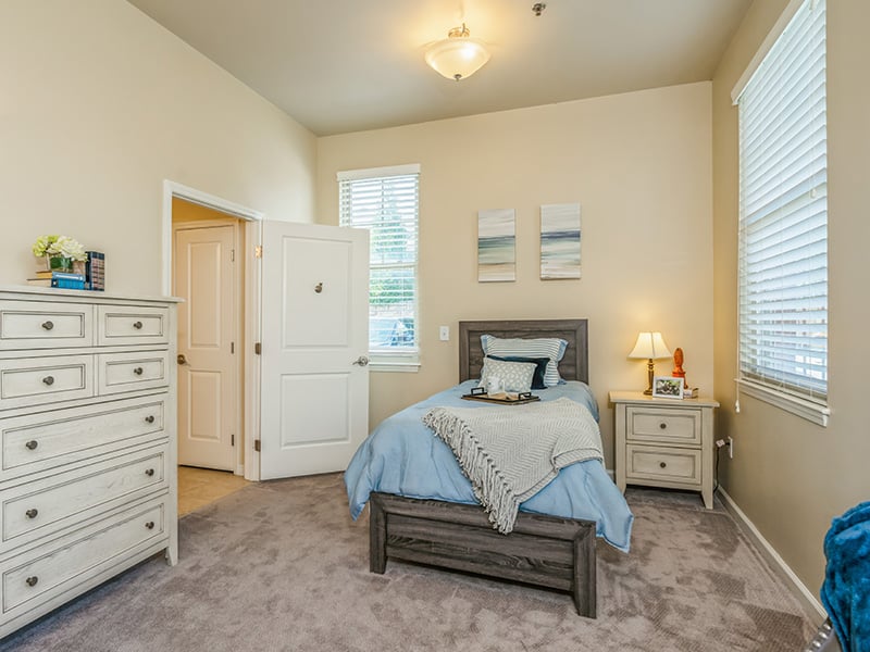 A spacious and comfortable bedroom within a senior apartment at Cedarhurst of East Louisville
