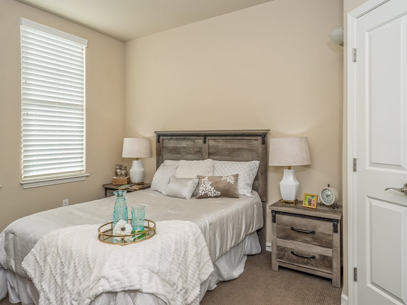 Bedroom of a senior apartment at Cedarhurst of East Louisville, designed for comfort and personalization