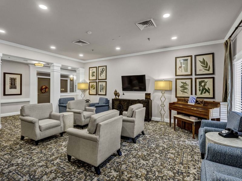 A beautifully designed common area at Cedarhurst of East Louisville, offering a welcoming space for residents to connect, featuring comfortable seating