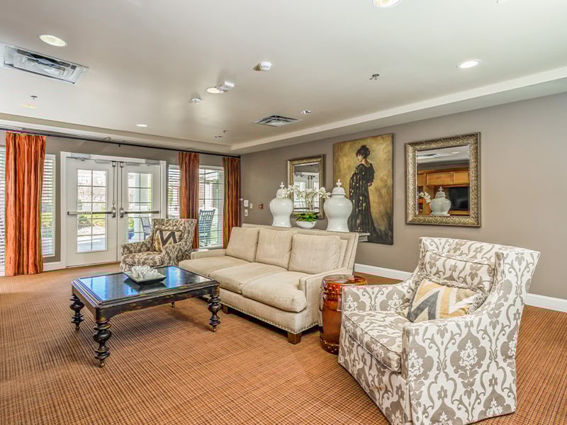 A beautifully designed common area at Cedarhurst of East Louisville, offering a welcoming space for residents to connect, featuring comfortable seating