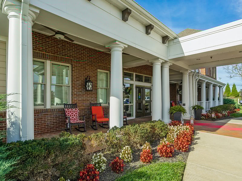 Versatile outdoor patio at Cedarhurst of East Louisville, featuring conversational seating and shaded areas