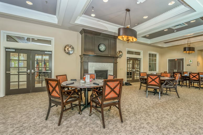 A spacious and bright dining room at Cedarhurst of East Louisville, offering comfortable seating for meals