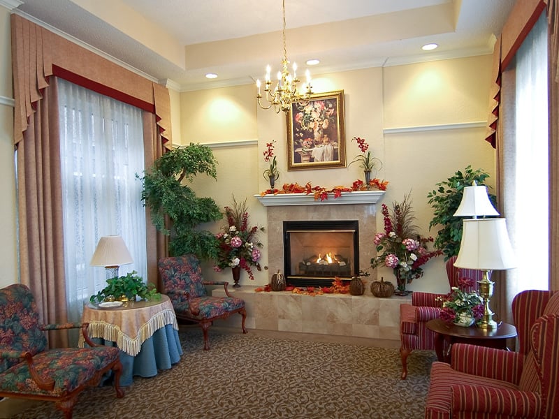 Welcoming common area at Cedarhurst of Edison Lakes, complete with comfortable furniture and a warm fireplace for relaxation and socialization