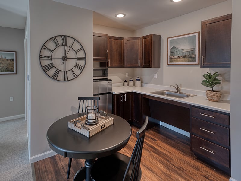 An accessible kitchenette in a senior apartment at Cedarhurst of Farmington, designed for ease of use and independence