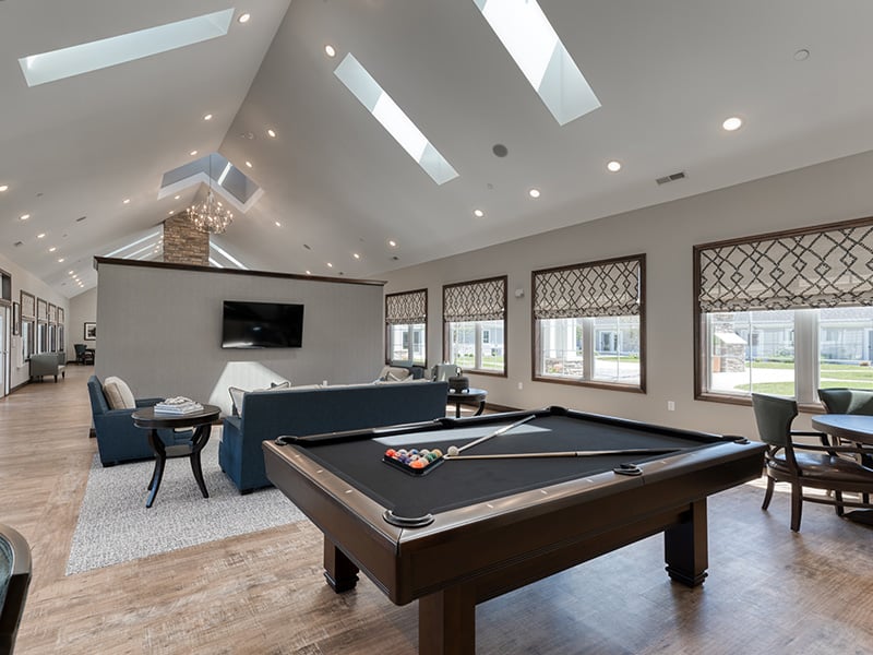 Well-equipped game room with a pool table at Cedarhurst of Farmington
