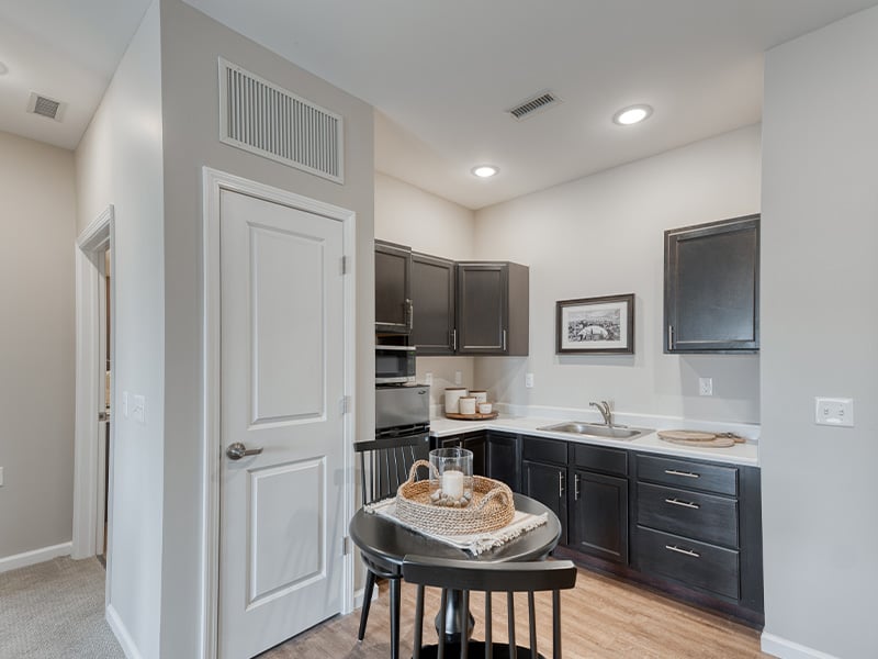 An accessible kitchenette in a senior apartment at Cedarhurst of Fort Wayne, designed for ease of use and independence
