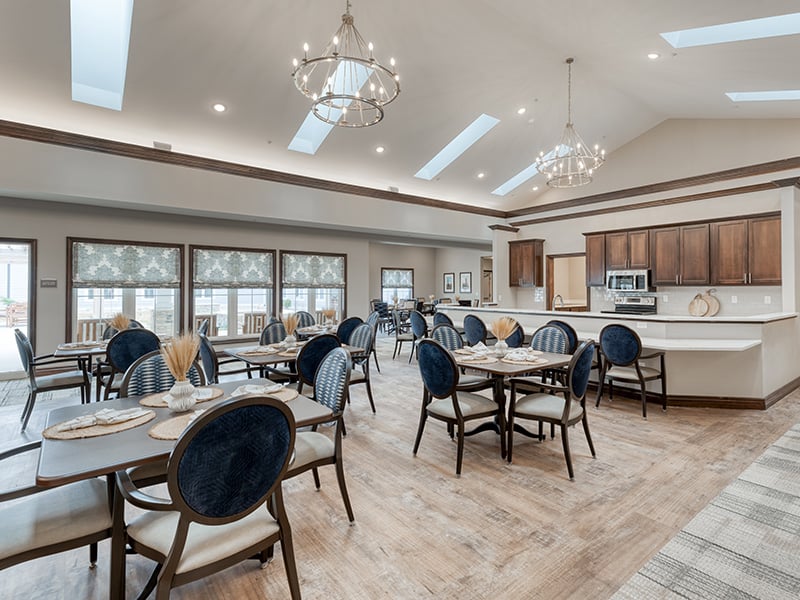 The spacious and inviting dining area at Cedarhurst of Fort Wayne, offering comfortable seating for residents