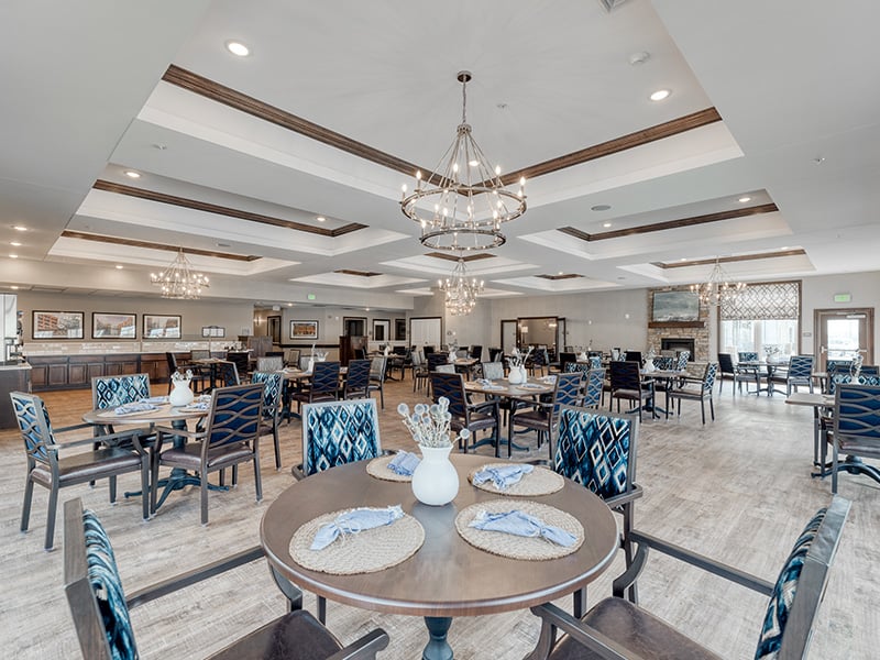 A spacious and bright dining room at Cedarhurst of Fort Wayne, offering comfortable seating for meals