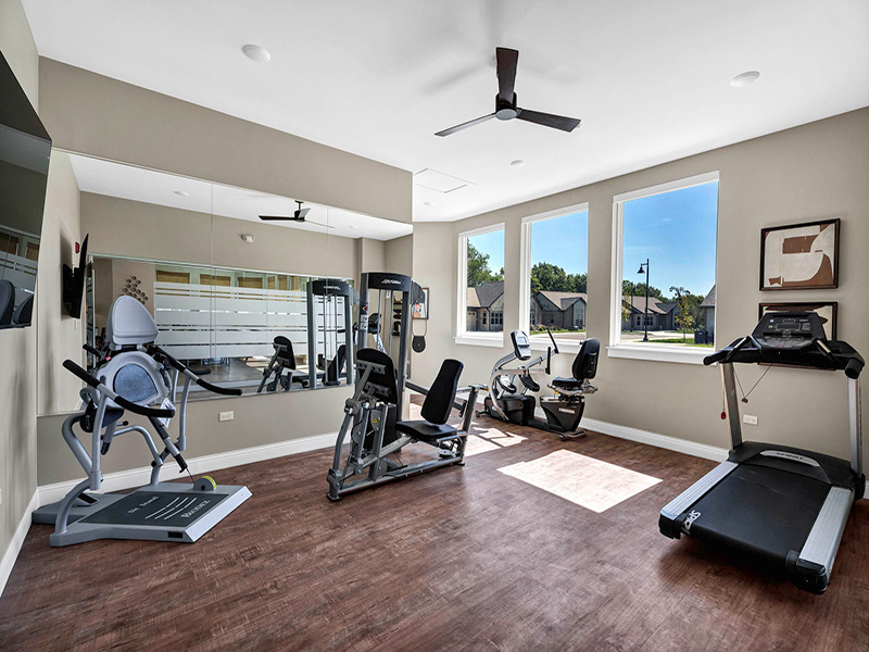 A well-equipped fitness center at Cedarhurst Cottages at Cedarhurst of Frankfort, offering exercise equipment and a comfortable space for independent living residents to stay active