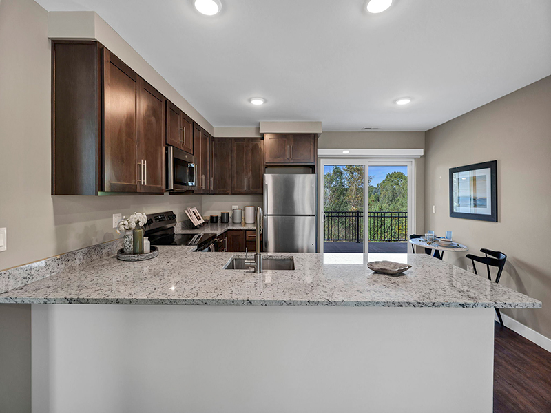 A full kitchen with island inside of Cedarhurst of Frankfort's Independent Living at Cedarhurst Cottages
