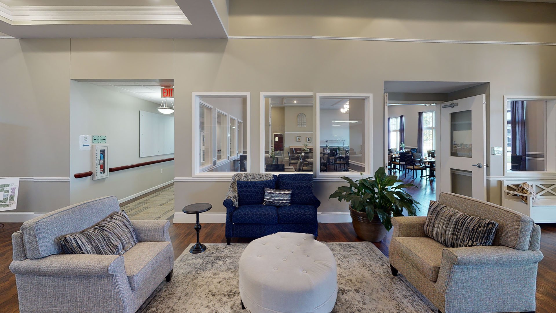 A spacious and inviting common area at Cedarhurst of Highland, designed for connection with comfortable seating for residents across all living option