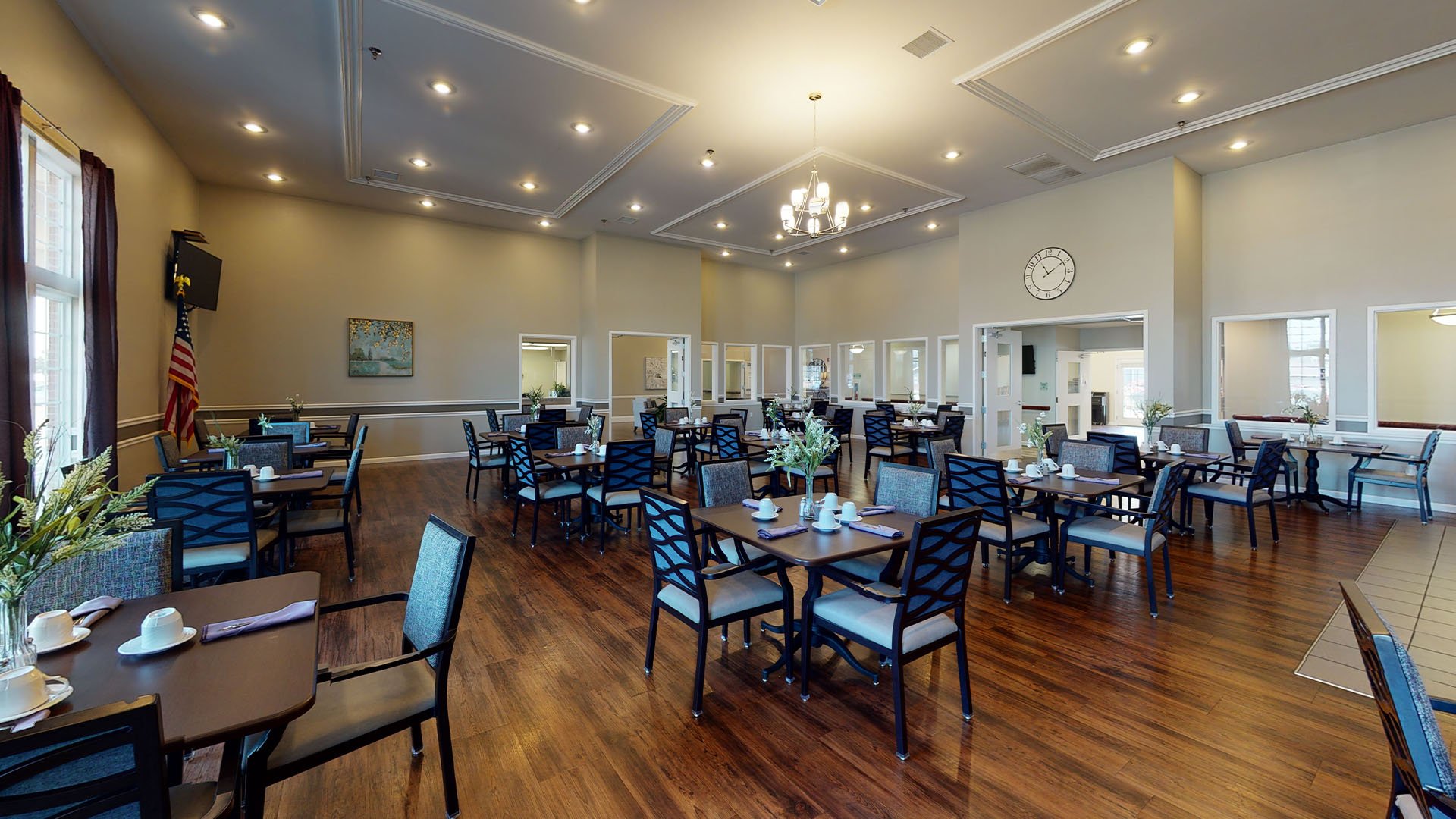 A spacious and bright dining room at Cedarhurst of Highland, offering comfortable seating for meals