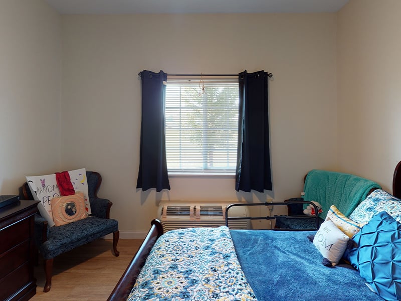 Bedroom of a senior apartment at Cedarhurst of Highland, designed for resident comfort and personalization