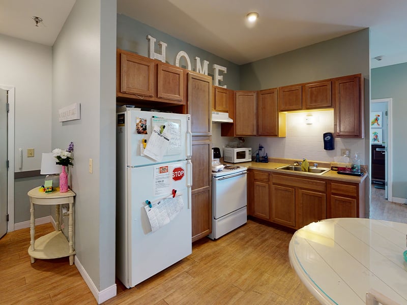 An accessible kitchenette in a senior apartment at Cedarhurst of Highland, designed for ease of use and independence