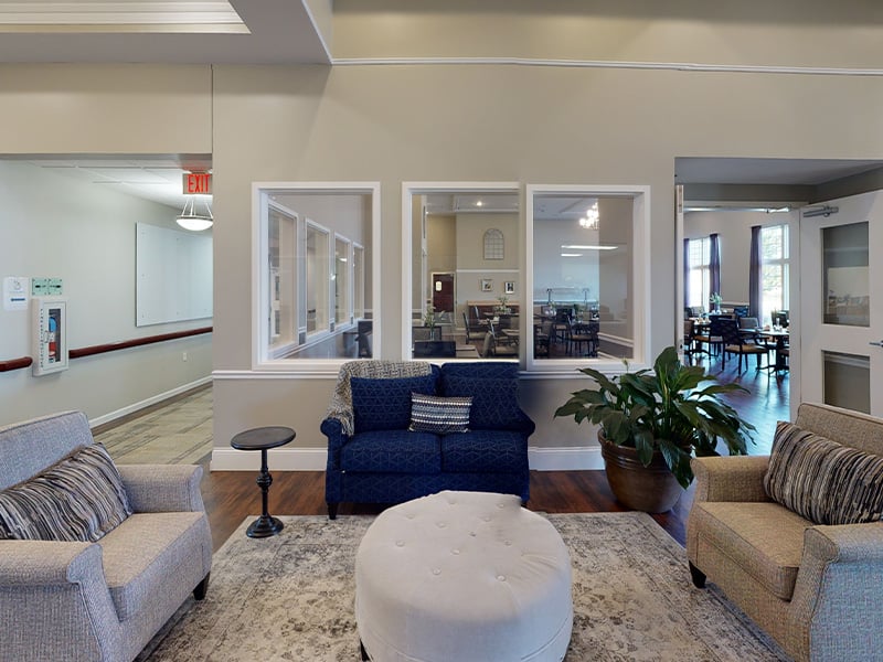 A spacious and inviting common area at Cedarhurst of Highland, designed for connection with comfortable seating for residents across all living options