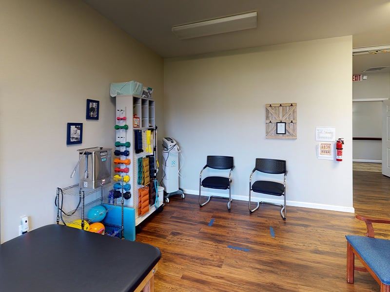 The dedicated physical therapy room at Cedarhurst of Highland, equipped with accessible equipment for resident rehabilitation and wellness