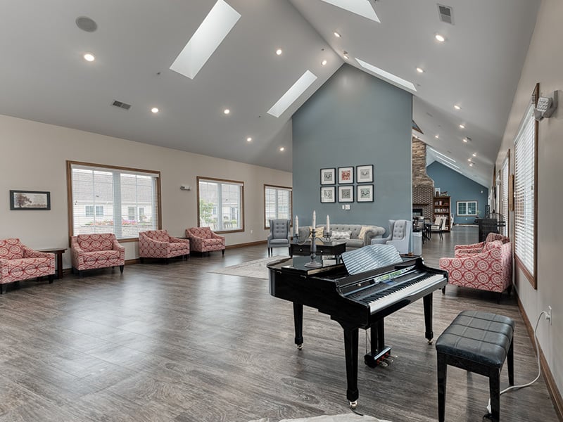 Common area—complete with a piano and ample seating—where residents can enjoy music and relaxation